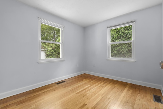 80 Holly St, Milford, CT 06460 - empty room featuring light wood-style flooring and plenty of natural light