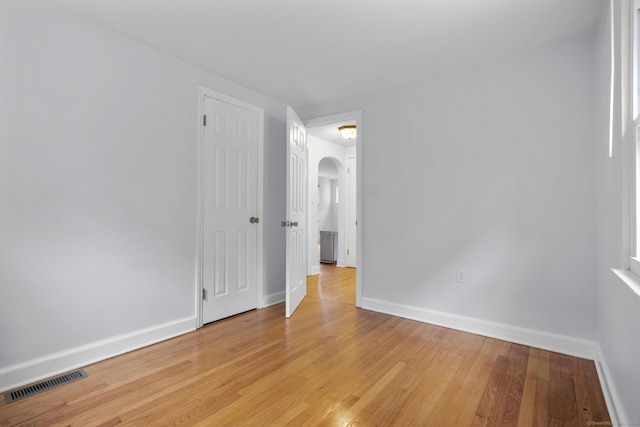 80 Holly St, Milford, CT 06460 - spare room featuring arched walkways and light wood-type flooring