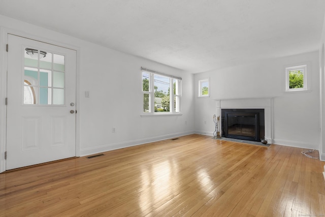 80 Holly St, Milford, CT 06460 - unfurnished living room with light wood-style flooring and a fireplace with flush hearth