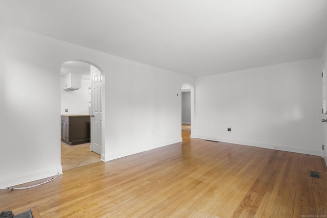 80 Holly St, Milford, CT 06460 - spare room featuring arched walkways and light wood-style floors