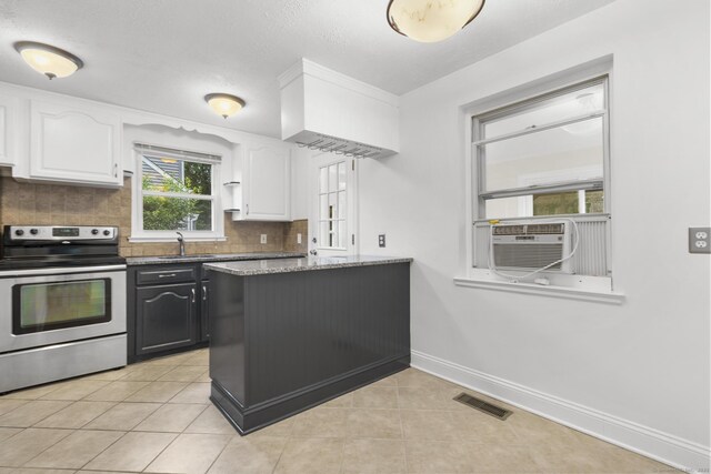 80 Holly St, Milford, CT 06460 - kitchen with stainless steel electric range oven, white cabinetry, tasteful backsplash, cooling unit, and light tile patterned floors