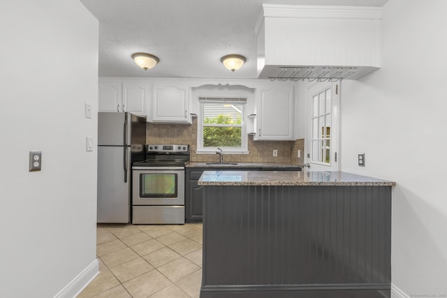 80 Holly St, Milford, CT 06460 - kitchen with stainless steel appliances, white cabinets, backsplash, and dark stone counters