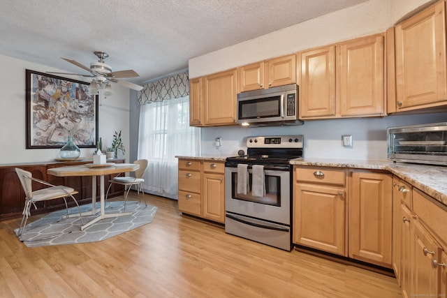 53 Daytona St, West Haven, CT 06516 - kitchen featuring stainless steel appliances, a textured ceiling, light wood-type flooring, light brown cabinets, and a ceiling fan