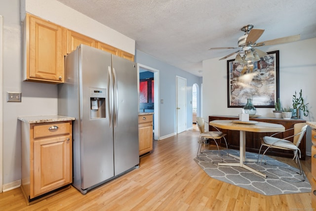 53 Daytona St, West Haven, CT 06516 - kitchen featuring stainless steel fridge, light wood-style flooring, a ceiling fan, a textured ceiling, and arched walkways