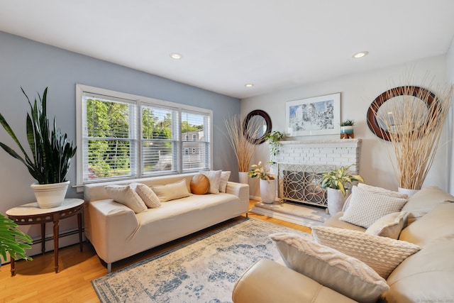 53 Daytona St, West Haven, CT 06516 - living room with a baseboard radiator, wood finished floors, a fireplace, and recessed lighting