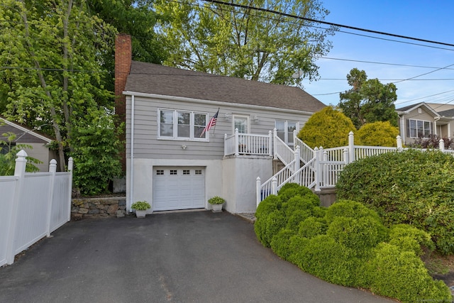 53 Daytona St, West Haven, CT 06516 - view of front of property featuring driveway, a chimney, a garage, stairs, and roof with shingles