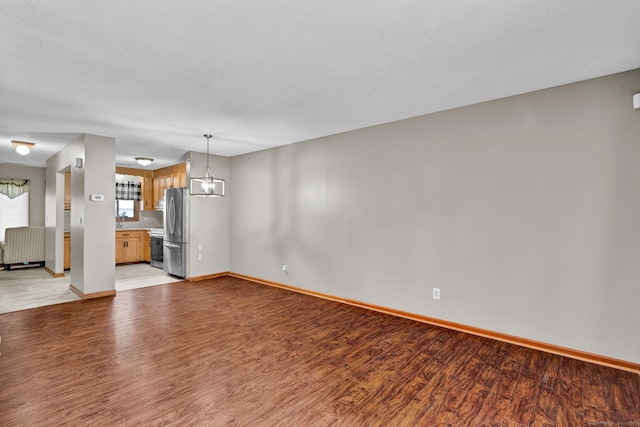 410 Emmett St Unit 45, Bristol, CT 06010 - unfurnished living room featuring light wood-style flooring and baseboards