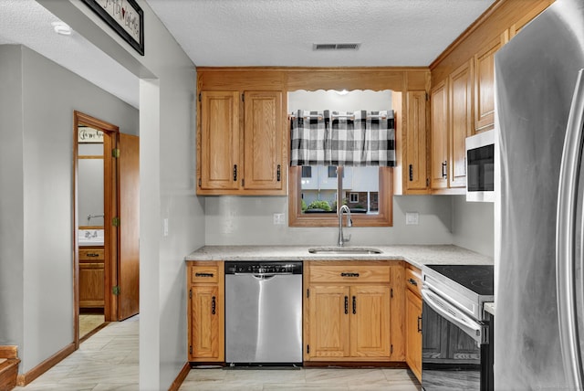 410 Emmett St Unit 45, Bristol, CT 06010 - kitchen featuring stainless steel appliances, light countertops, and a textured ceiling
