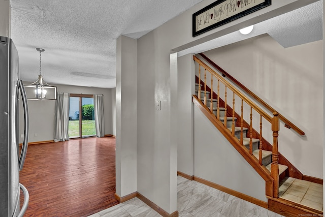 410 Emmett St Unit 45, Bristol, CT 06010 - stairs featuring a textured ceiling and baseboards