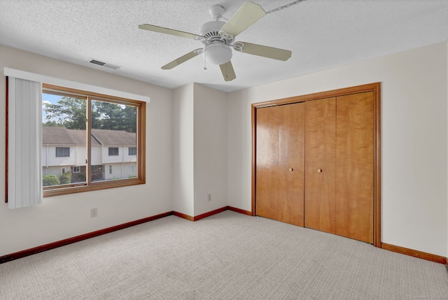 410 Emmett St Unit 45, Bristol, CT 06010 - unfurnished bedroom featuring light carpet, a closet, ceiling fan, and a textured ceiling