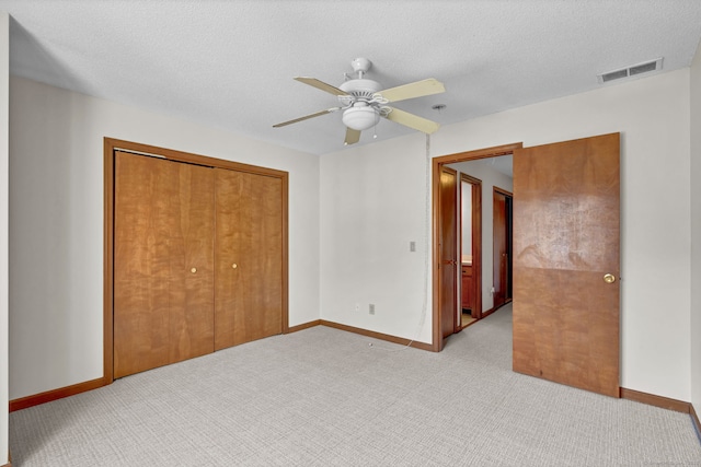 410 Emmett St Unit 45, Bristol, CT 06010 - unfurnished bedroom with a closet, light carpet, ceiling fan, and a textured ceiling