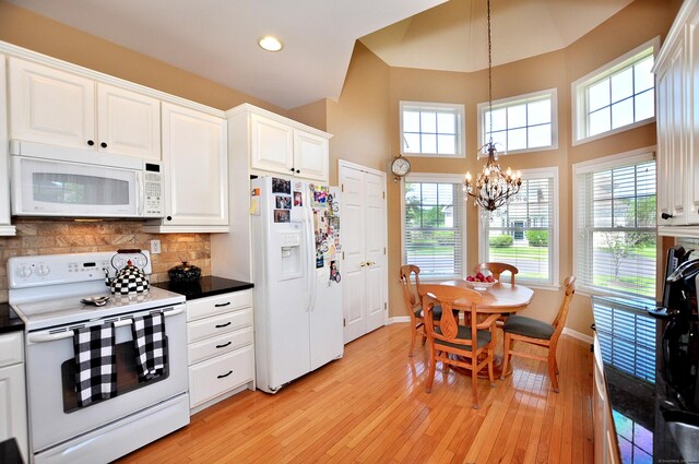20 Carnoustie Cir, Bloomfield, CT 06002 - kitchen featuring white appliances, a chandelier, light wood-style floors, white cabinetry, and decorative backsplash