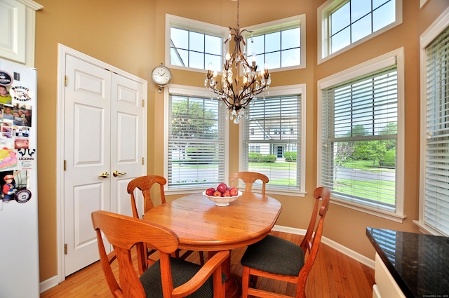 20 Carnoustie Cir, Bloomfield, CT 06002 - dining room featuring light wood finished floors, a chandelier, plenty of natural light, and a high ceiling
