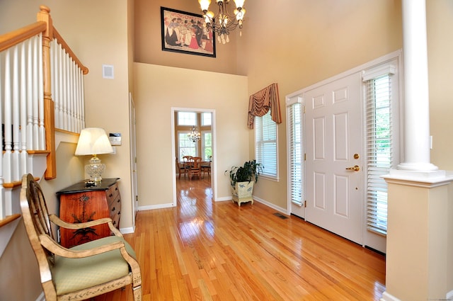 20 Carnoustie Cir, Bloomfield, CT 06002 - foyer entrance with a chandelier, light wood-style floors, a high ceiling, and ornate columns