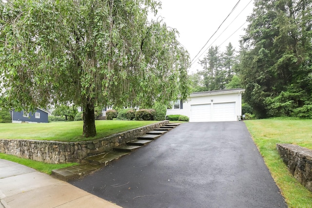 57 Apple Tree Ln, Hamden, CT 06518 - view of property hidden behind natural elements with driveway, a garage, and a front yard
