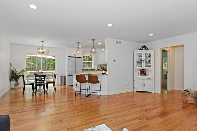 6 S Bear Hill Rd, Chaplin, CT 06235 - kitchen with freestanding refrigerator, white cabinets, recessed lighting, a peninsula, and light wood-style flooring