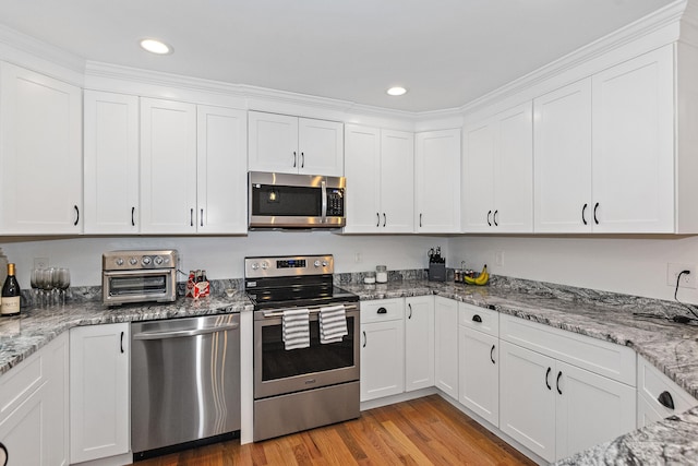 6 S Bear Hill Rd, Chaplin, CT 06235 - kitchen featuring stainless steel appliances, white cabinets, light wood-style flooring, light stone countertops, and recessed lighting