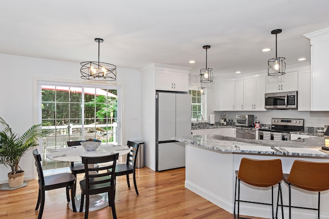 6 S Bear Hill Rd, Chaplin, CT 06235 - kitchen featuring stainless steel appliances, light stone countertops, white cabinetry, light wood finished floors, and recessed lighting