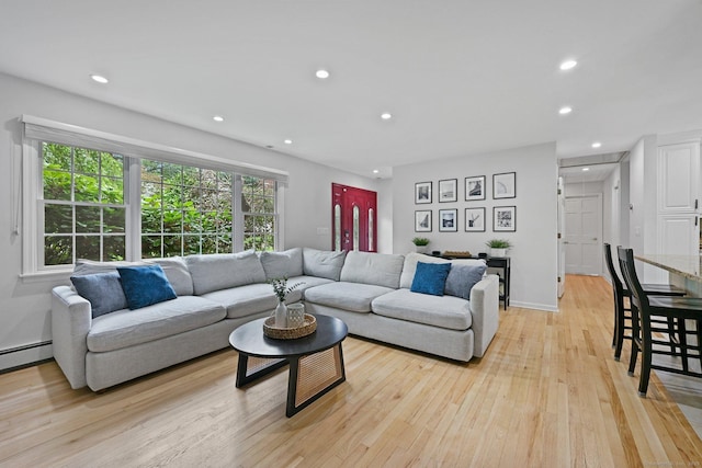 10 Eric Ct, Norwalk, CT 06851 - living area featuring light wood-type flooring, recessed lighting, and a baseboard heating unit
