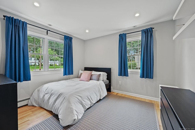 10 Eric Ct, Norwalk, CT 06851 - bedroom featuring baseboard heating, wood finished floors, and recessed lighting