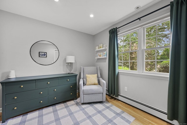 10 Eric Ct, Norwalk, CT 06851 - living area with a baseboard radiator, light wood-style floors, and recessed lighting