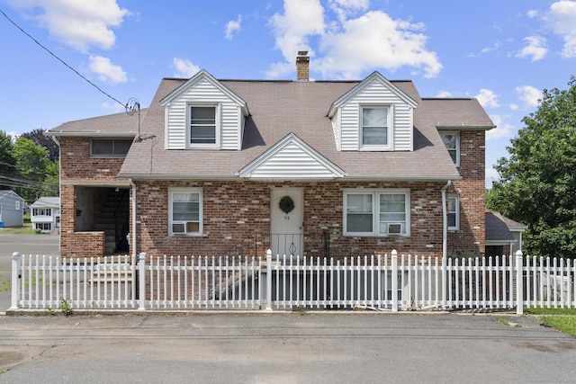 52 Colony St, Bristol, CT 06010 - cape cod house with brick siding, a fenced front yard, and a chimney