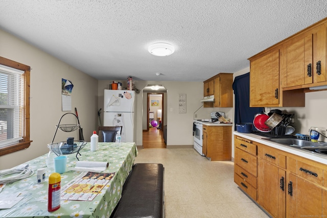 52 Colony St, Bristol, CT 06010 - kitchen featuring white appliances, light countertops, arched walkways, light floors, and brown cabinets