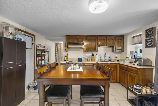 52 Colony St, Bristol, CT 06010 - kitchen with under cabinet range hood, light countertops, light tile patterned floors, a textured ceiling, and double oven range