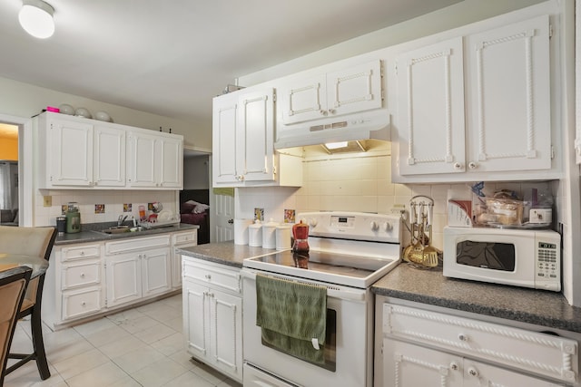 17 Pleasant St, Danbury, CT 06810 - kitchen featuring white appliances, under cabinet range hood, tasteful backsplash, and dark countertops