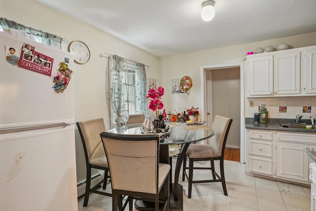 17 Pleasant St, Danbury, CT 06810 - dining space featuring baseboard heating, plenty of natural light, and light tile patterned floors