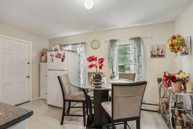 17 Pleasant St, Danbury, CT 06810 - dining area with light tile patterned flooring and a baseboard radiator