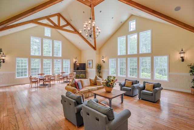 7 Concord Ct Unit 7, Southbury, CT 06488 - living room with high vaulted ceiling, beam ceiling, light wood finished floors, wainscoting, and a chandelier