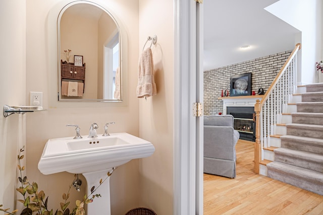 7 Concord Ct Unit 7, Southbury, CT 06488 - bathroom featuring a glass covered fireplace and wood finished floors