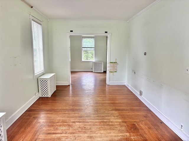154 Golden St, Norwich, CT 06360 - spare room with crown molding, radiator heating unit, and light wood-style flooring