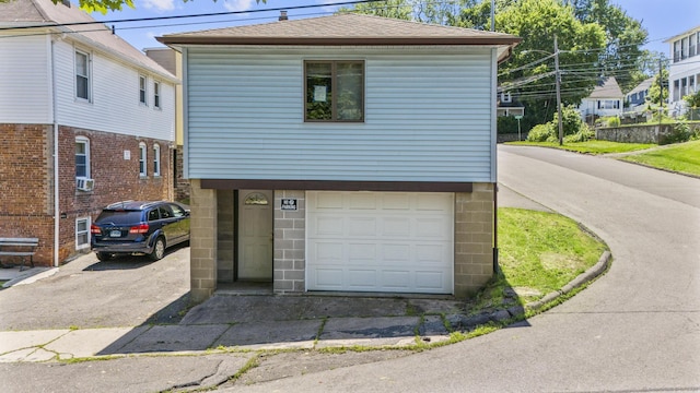 53 Norton St, Bristol, CT 06010 - view of front of property featuring asphalt driveway, a garage, roof with shingles, and cooling unit