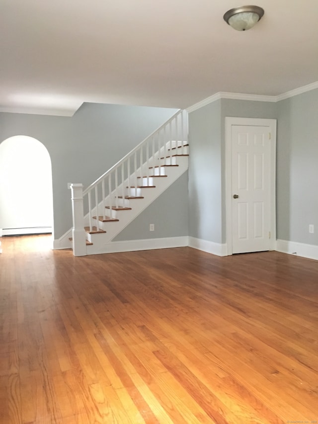 1333 Blue Hills Ave, Bloomfield, CT 06002 - unfurnished living room with stairs, a baseboard heating unit, light wood-style floors, and ornamental molding
