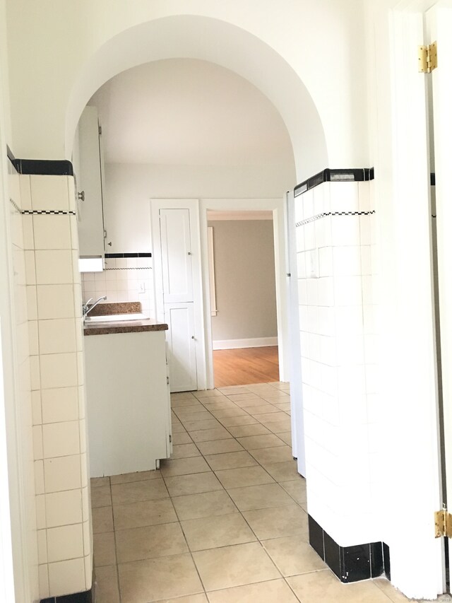 1333 Blue Hills Ave, Bloomfield, CT 06002 - hallway with arched walkways and light tile patterned floors