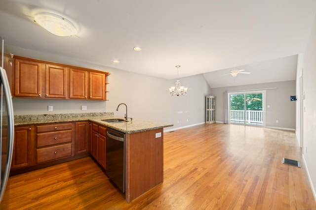 44 Forshaw Ave Unit 44, Plainville, CT 06062 - kitchen featuring appliances with stainless steel finishes, a peninsula, a chandelier, lofted ceiling, and light wood-style flooring