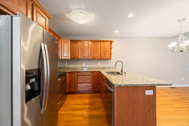 44 Forshaw Ave Unit 44, Plainville, CT 06062 - kitchen with stainless steel appliances, a peninsula, light wood-style flooring, a chandelier, and open shelves