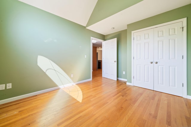 44 Forshaw Ave Unit 44, Plainville, CT 06062 - unfurnished bedroom with light wood finished floors, a closet, and vaulted ceiling