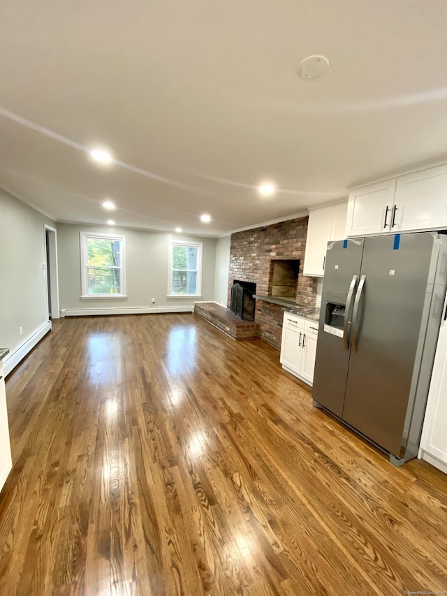 545 Simsbury Rd, Bloomfield, CT 06002 - unfurnished living room with dark wood-style flooring, a fireplace, a baseboard heating unit, and recessed lighting