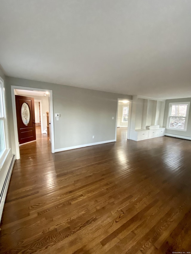 545 Simsbury Rd, Bloomfield, CT 06002 - unfurnished living room with dark wood-style flooring and baseboard heating
