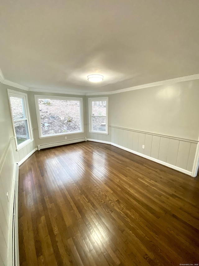 545 Simsbury Rd, Bloomfield, CT 06002 - spare room featuring a baseboard heating unit, crown molding, dark wood-type flooring, a wainscoted wall, and healthy amount of natural light
