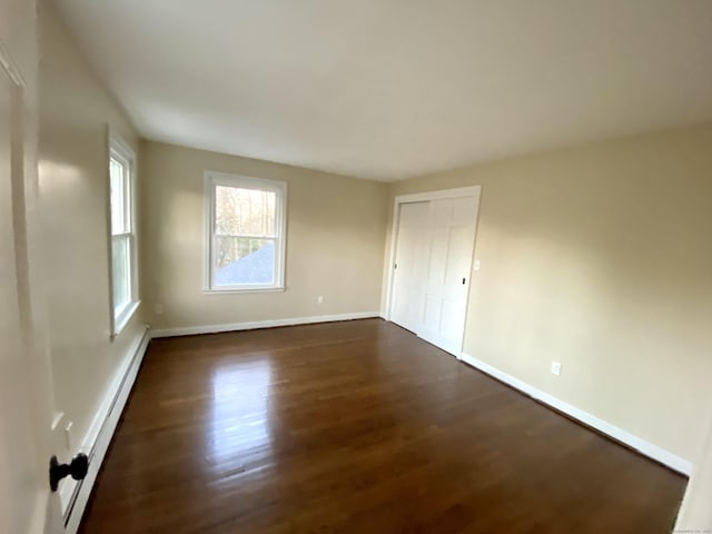 545 Simsbury Rd, Bloomfield, CT 06002 - empty room with baseboard heating and dark wood-style floors