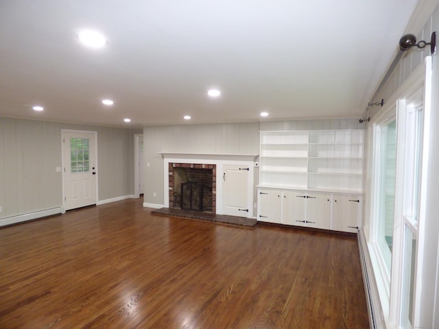 545 Simsbury Rd, Bloomfield, CT 06002 - unfurnished living room with dark wood-style floors, a brick fireplace, recessed lighting, and a baseboard heating unit
