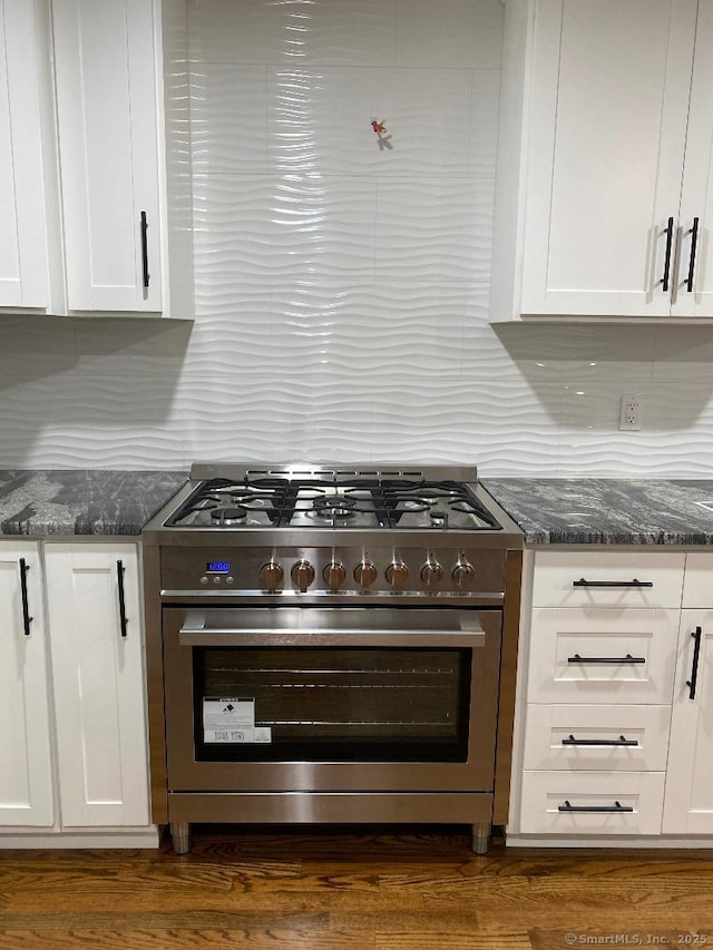545 Simsbury Rd, Bloomfield, CT 06002 - kitchen featuring high end stainless steel range, white cabinets, dark stone counters, and backsplash