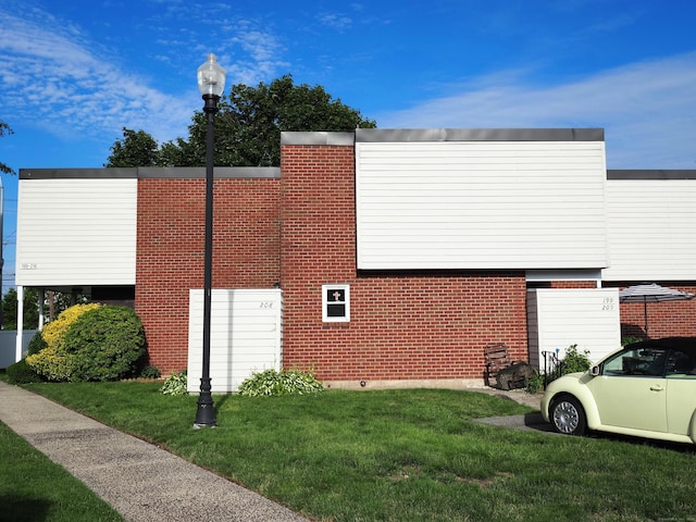208 W Walk Unit 208, West Haven, CT 06516 - view of property exterior featuring brick siding and a lawn