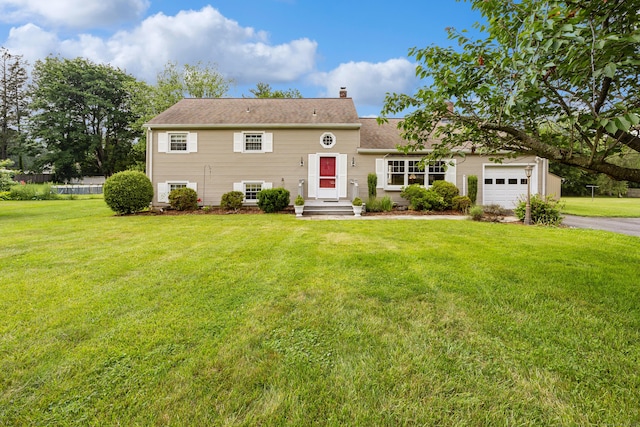 1519 Tuttle Ave, Wallingford, CT 06492 - view of front facade with a garage, asphalt driveway, a front lawn, and a chimney