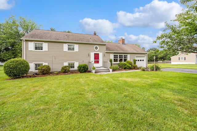 1519 Tuttle Ave, Wallingford, CT 06492 - view of front of home featuring a chimney, an attached garage, driveway, and a front lawn