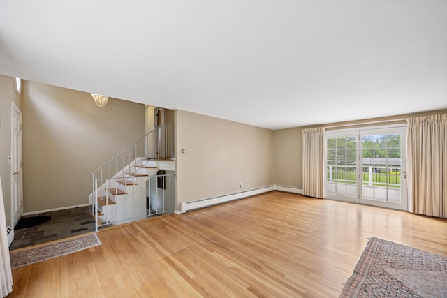 1519 Tuttle Ave, Wallingford, CT 06492 - unfurnished living room featuring light wood finished floors, baseboard heating, stairs, and a baseboard radiator